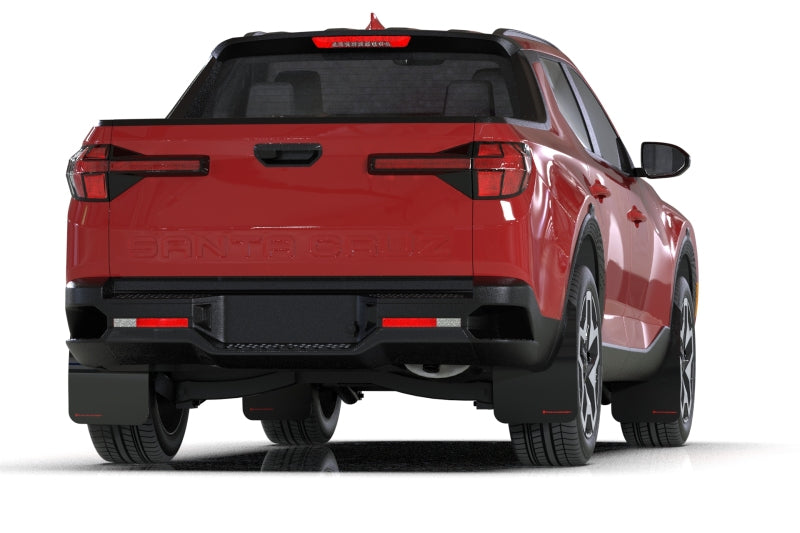 Rally Armor black mud flaps with grey logo on a Hyundai Santa Cruz, protecting the wheel well from dirt and debris.