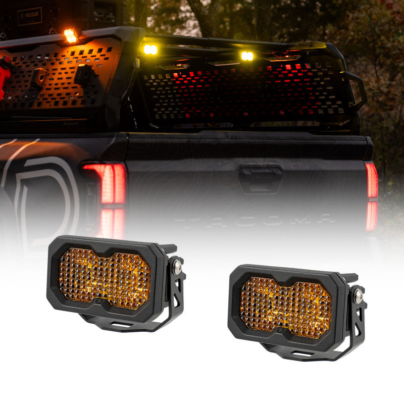 Diode Dynamics Stage Series LED chase light kit with multiple light bars and cubes mounted on Kuat IBEX bed rack for off-road lighting.