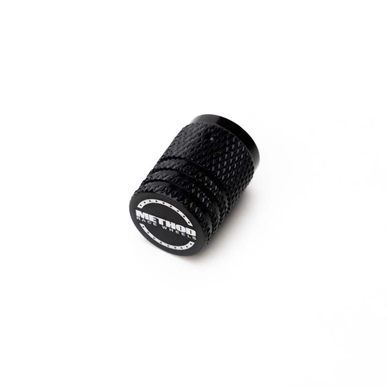 Set of five black Method Wheels valve stem caps, durable rubber and metal construction for vehicle tire valves.