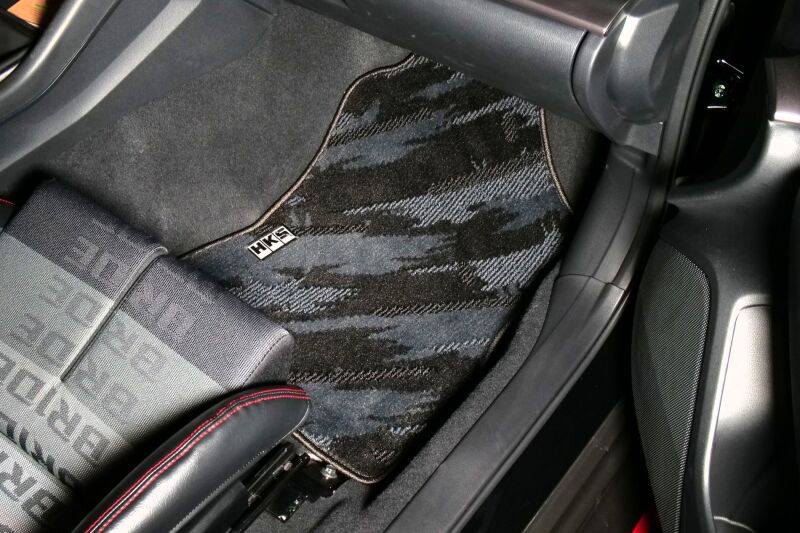 HKS full set of carpeted floor mats for October LHD vehicle, showing black textured surface and fitted design.