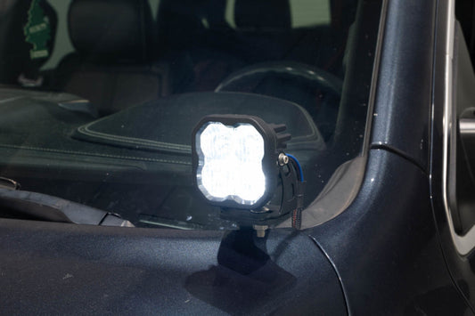 Diode Dynamics Stage Series ditch light bracket kit mounted on a 2019-present Ram truck for off-road lighting.