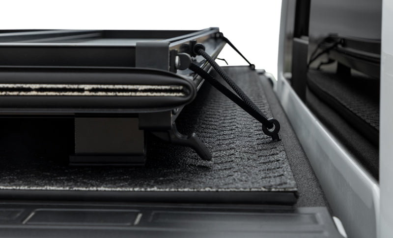 Access LOMAX Pro Series 19+ Chevy/GMC full-size 1500 hard fold tonneau cover in Black Diamond Mist with carbon fiber look finish.
