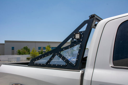 DV8 Offroad Chase Rack installed on Ram 2500/3500 trucks, durable black steel bolt-on offroad accessory with mounting points.