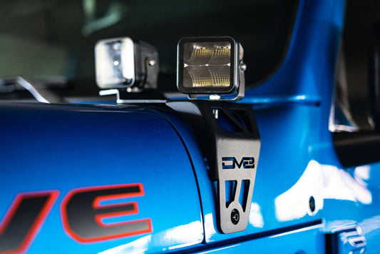 DV8 Offroad Jeep JL 392/JT Mojave dual pod light mounts installed on vehicle front, showcasing sturdy metal construction.