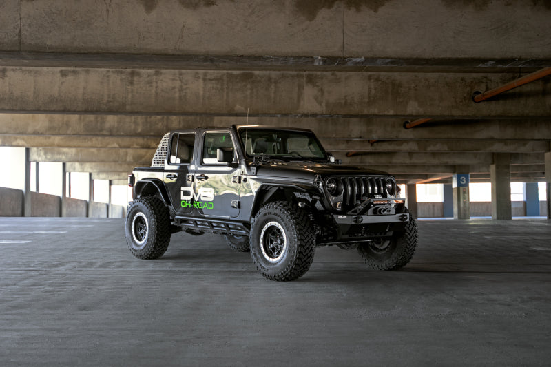 Steel DV8 Offroad FS-25 stubby front bumper with plated bull bar for Jeep Wrangler and Gladiator JT/JK/JL models.