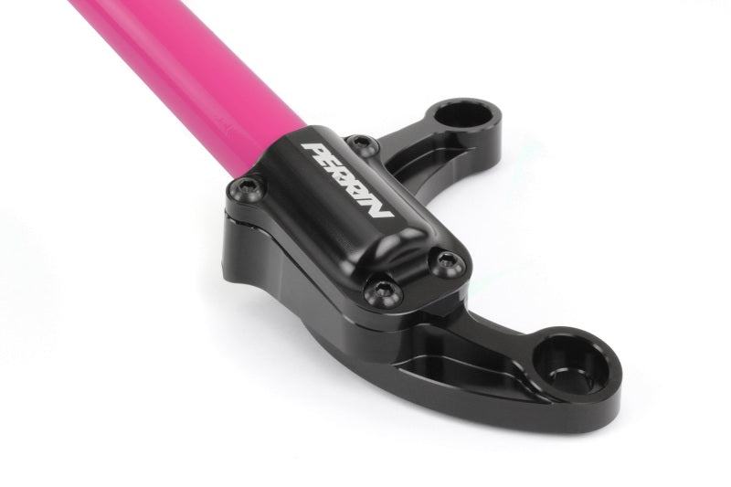 Perrin Performance front strut brace in hyper pink for Subaru WRX, STi, Impreza, and Forester models, visible mounted on vehicle suspension.