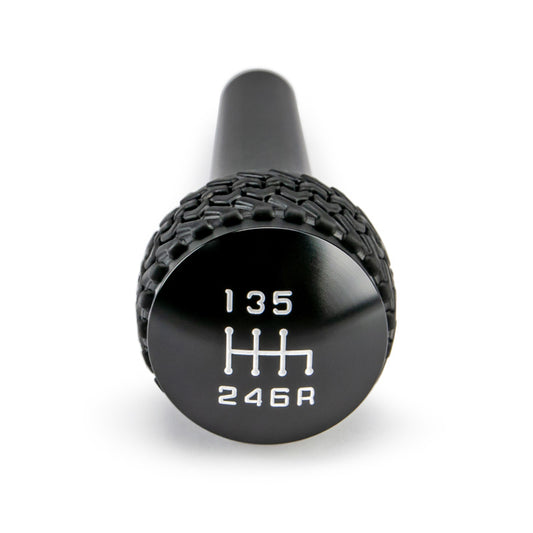 Black finish DV8 Offroad 6-speed shift knob for Jeep TJ and JK models, featuring durable construction and ergonomic design.