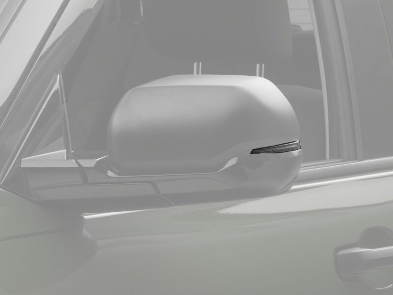 Raxiom 22-26 Toyota Tundra side mirrors with clear sequential LED mirror lights, showcasing modern lighting design.