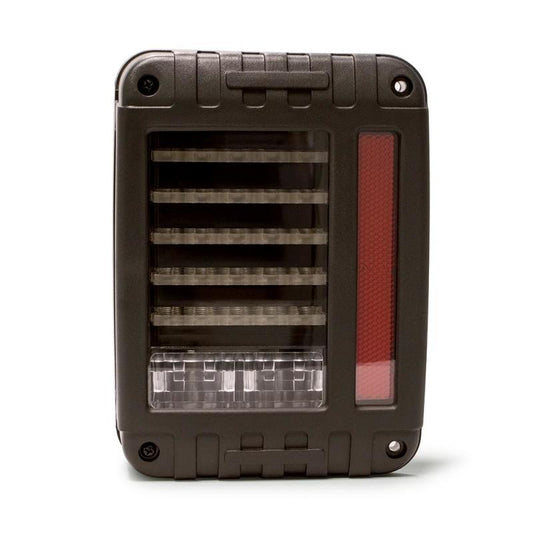 DV8 Offroad Jeep Wrangler JK octagon LED tail light showing bright red lens and black housing, mounted on vehicle rear.