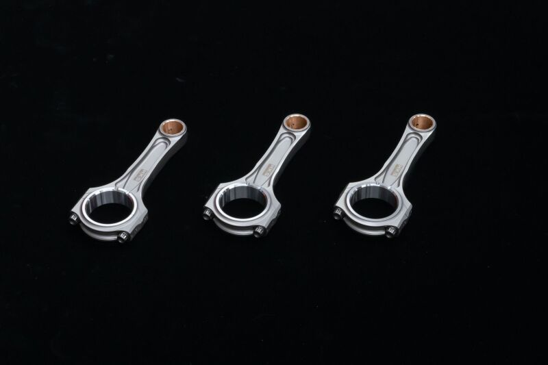 HKS G16E HC-TT connecting rod and piston kit with conrods, showcasing metal components for engine upgrade or repair.