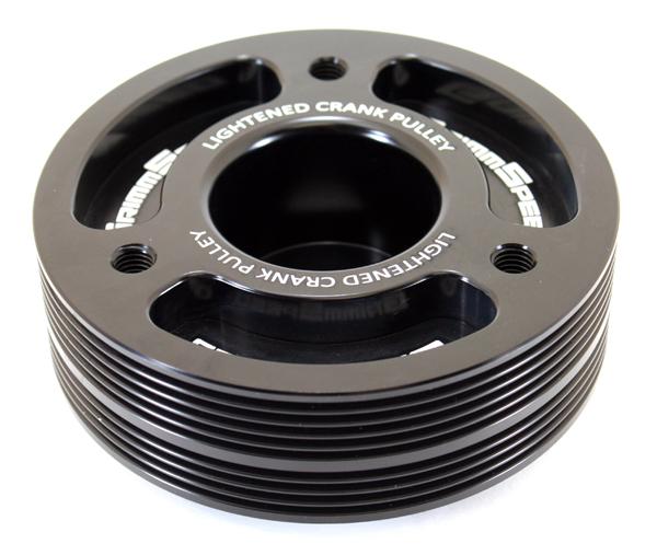 Black GrimmSpeed Subaru lightweight crank pulley for underdrive performance, shown installed on a Subaru engine.