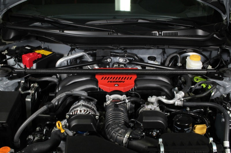 PERRIN carbon fiber front strut brace for Subaru BRZ, Toyota GR86, 86, and Scion FR-S, enhancing chassis stability and performance.