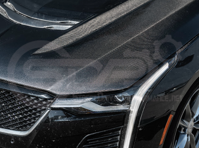 Black carbon fiber vented front hood for 2020+ Cadillac CT4 and CT4-V models, featuring Black Wing and Sport styling by Street Driven Performance.