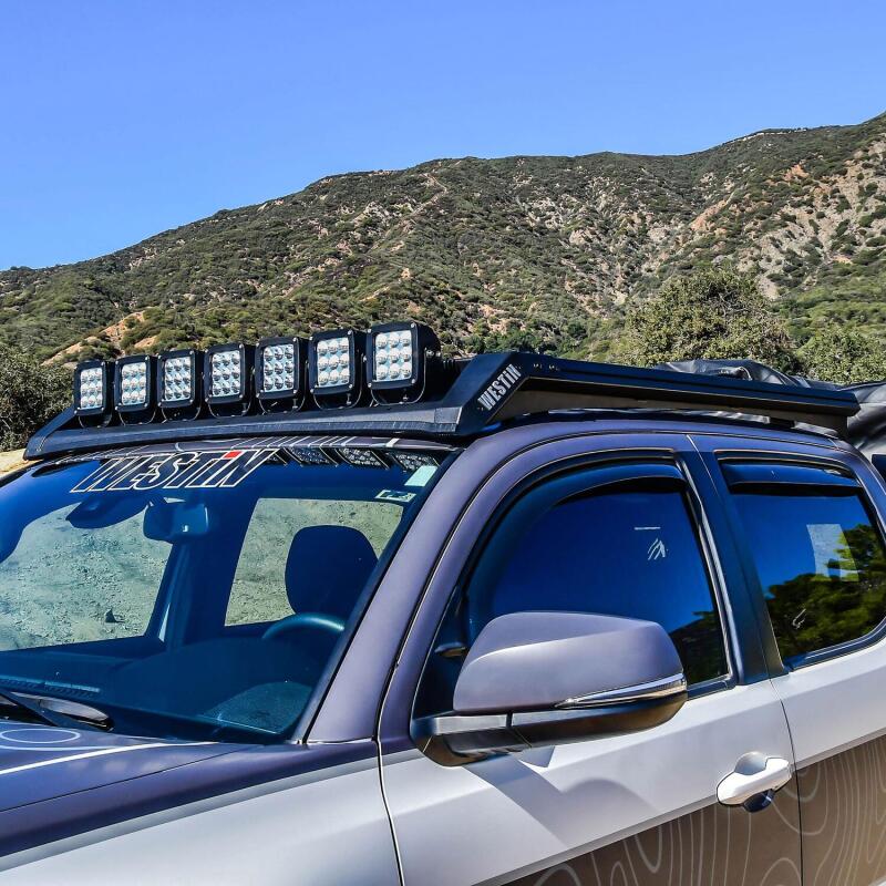 Westin Toyota Tacoma Mesa roof rack installed on a 16-23 model, durable black metal roof rack for cargo and gear.