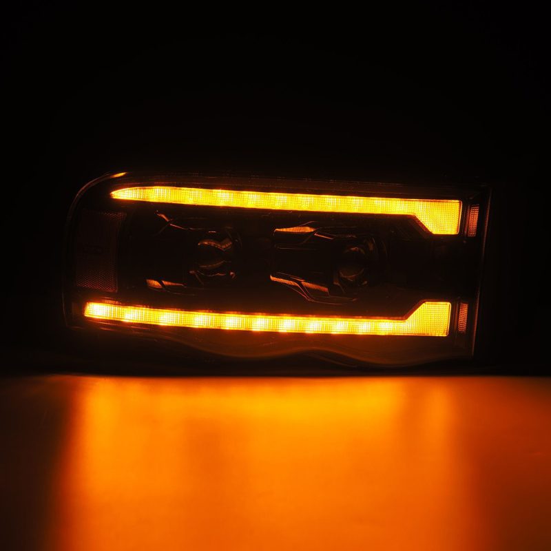 AlphaRex Alpha Black projector headlights with sequential signal for Dodge Ram 1500 2002-2005, plank style design.