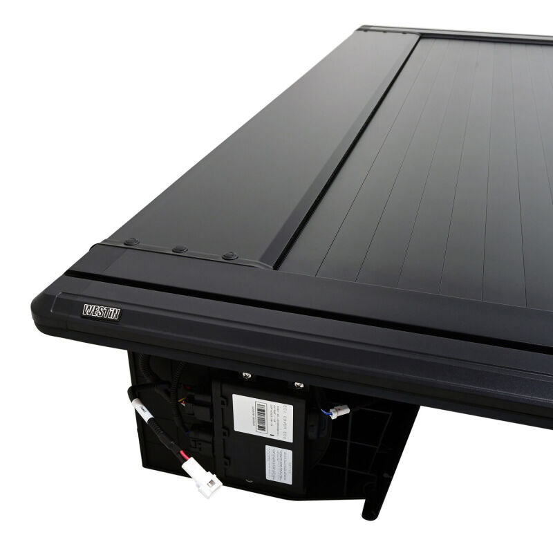 Westin retractable tonneau cover in black installed on a Ford F-250/F-350 SD with a 6.8ft bed, showing its sleek design.