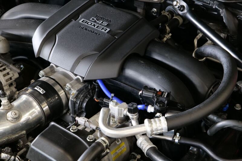 HKS pressure sensor kit for FA20/FA24 engines, gauge components with electrical connectors and sensor modules.