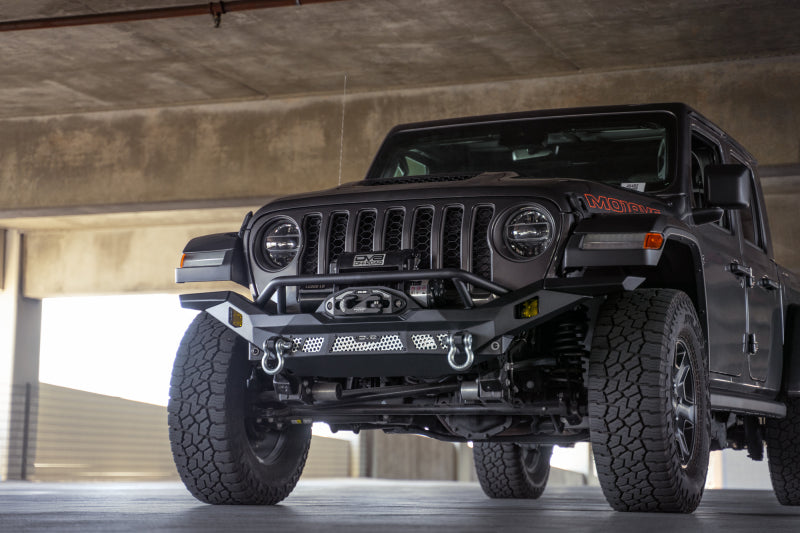 Steel front bumper from DV8 Offroad for Jeep Wrangler JK, JL, and Gladiator JT, featuring rugged off-road design.