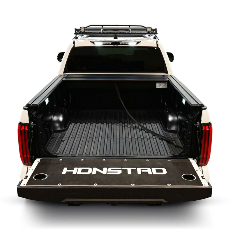 Westin manual retractable tonneau cover on a Toyota Tundra with 5.5ft bed, black roll-up style for truck bed protection.