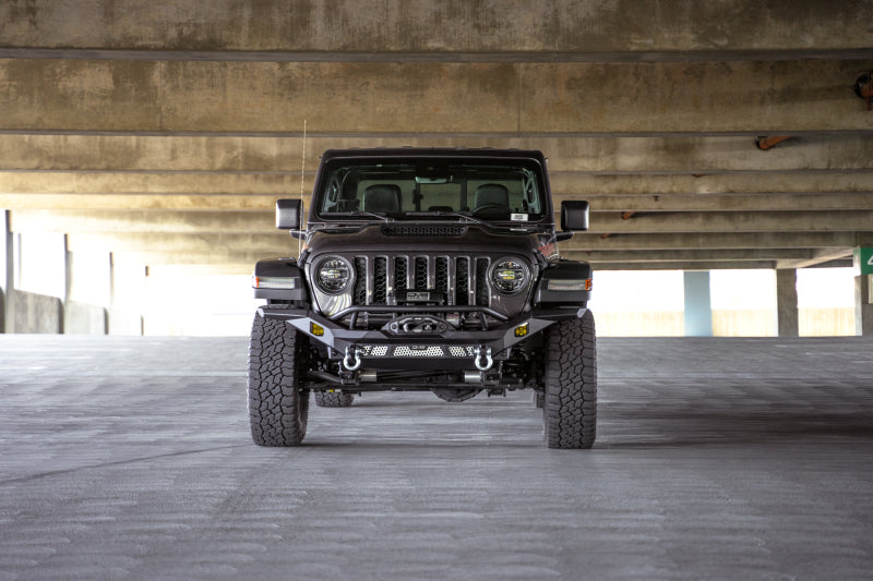 Steel front bumper by DV8 Offroad for Jeep Wrangler JK, JL, and Gladiator JT, featuring rugged off-road design.