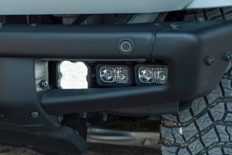 Diode Dynamics 21-Up Ford Bronco Stage Series fog lights with yellow sport lens installed in front bumper.