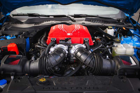 Roush 2026 Ford Mustang 5.0L supercharger kit installed, showcasing the high-performance supercharger components on a muscle car.