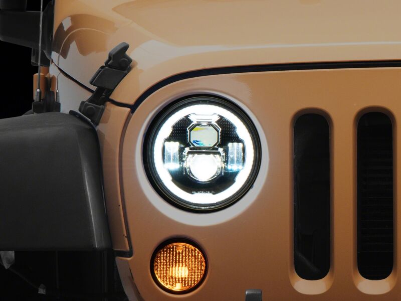 Raxiom 07-18 Jeep Wrangler Axial Series 7-inch LED headlights with black housing and clear lens, featuring daytime running lights.