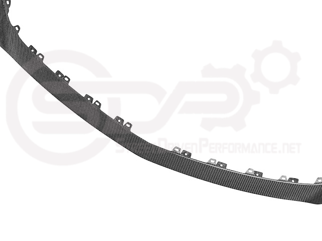 Cadillac CT5-V Blackwing factory OEM style carbon fiber front lip splitter and wheel arches on a sleek sports car.