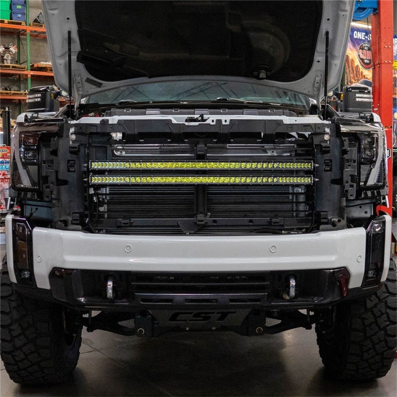 Rigid Industries GMC 2500/3500 HD grill radiance kit with LED light bars and cubes installed on the front grille.