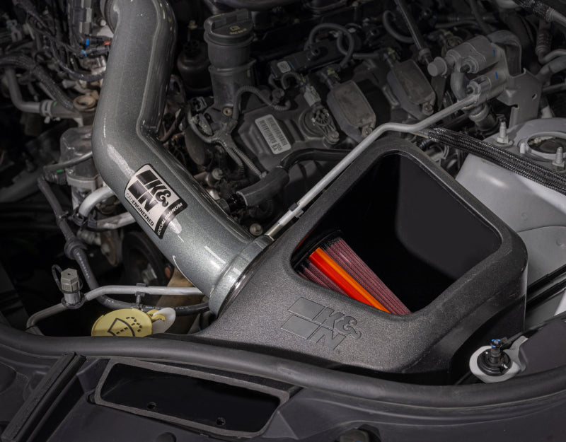 K&N Engineering NextGen aluminum cold air intake system installed in a Jeep Grand Cherokee 2016-2022, with polished metal components and air filter.
