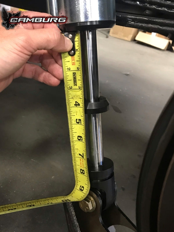 Camburg Toyota Tundra 2007-2021 rear shock mount kit with shock mounts and camber plates, shown installed on vehicle suspension.