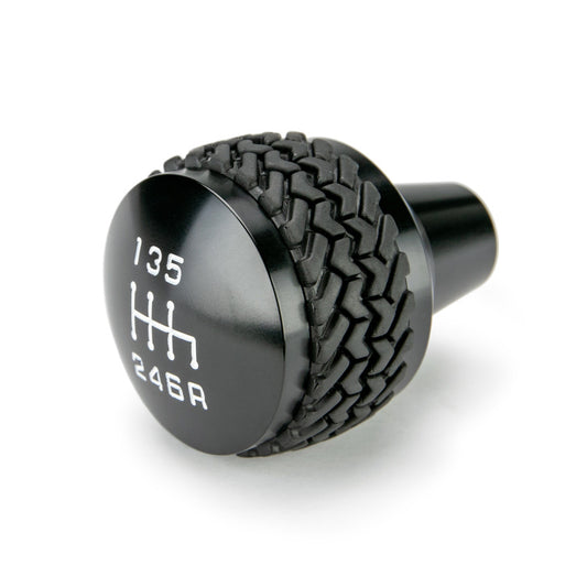 Black DV8 Offroad 2011-2018 Jeep JK 6-speed shift knob, close-up view showing textured grip and sleek design.