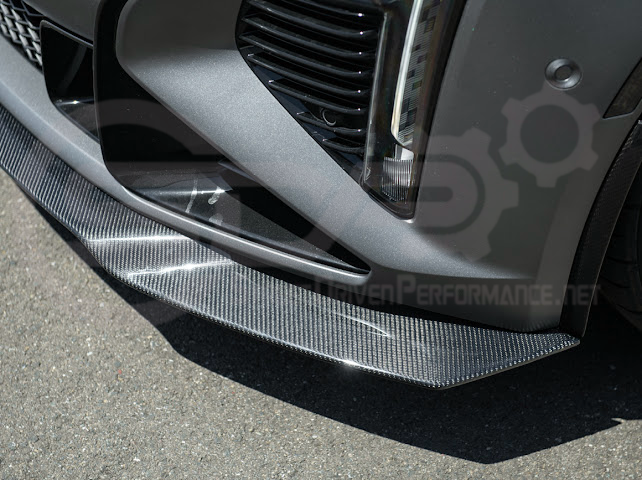 Factory OEM style carbon fiber front lip splitter and wheel arches for Cadillac CT5-V Blackwing, enhancing ground effects and sportiness.