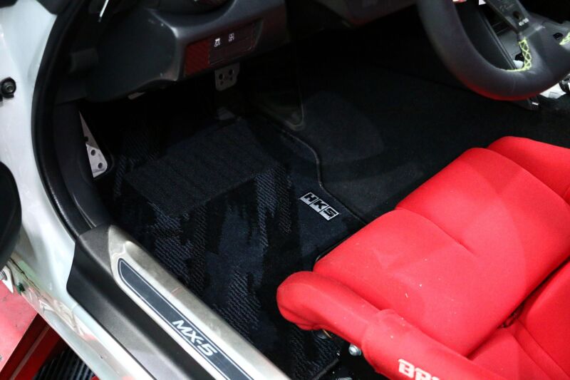 HKS carpeted floor mats set for Nissan ND, full LHD vehicle interior, includes driver and passenger side mats with logo.