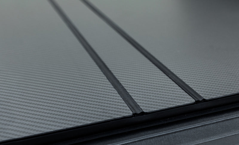 Access LOMAX Tri-Fold Cover for 2012-2018 Dodge RAM 1500 with 6ft 4in bed, carbon fiber exterior truck bed accessory.