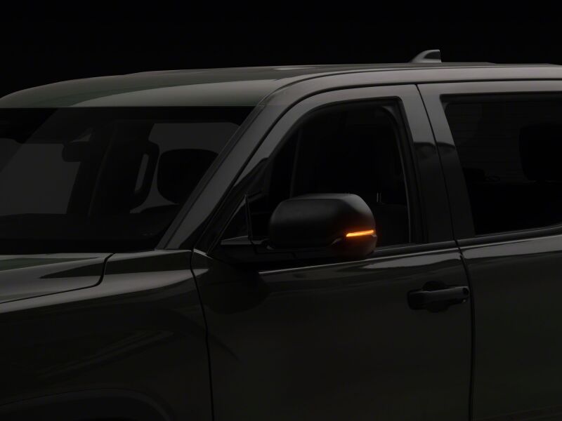 Raxiom smoked sequential LED side mirror lights for Toyota Tundra 22-26 models, installed on vehicle side mirrors.