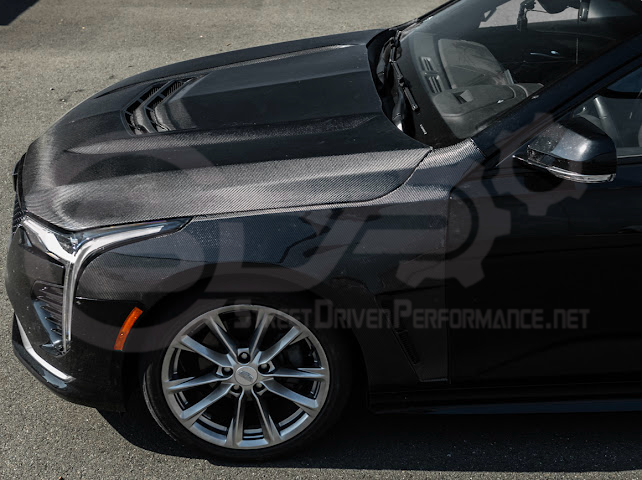 Cadillac CT4 Black Wing style carbon fiber vented front hood with sleek black finish and aerodynamic design.