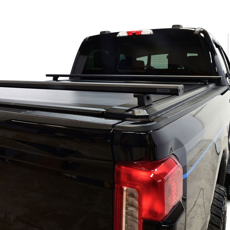 Westin retractable tonneau cover in black on Ford F-250/F-350 SD 6.8ft bed, showcasing the sleek, secure design.