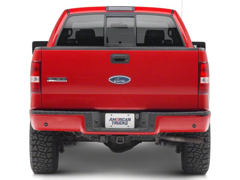 Raxiom Ford F-150 axial series LED third brake light installed on the vehicle's rear, showcasing bright illumination and sleek design.