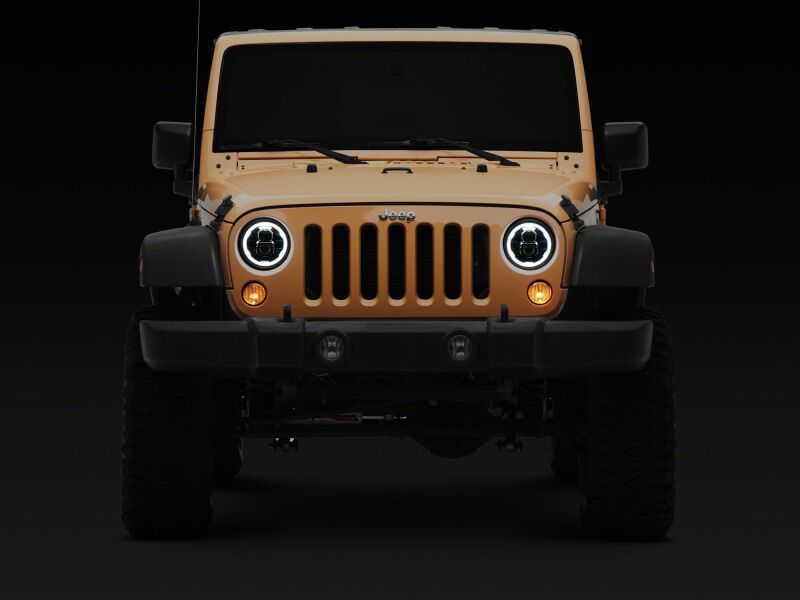Raxiom 07-18 Jeep Wrangler LED headlights with black housing and clear lens, featuring daytime running lights and 7-inch size.