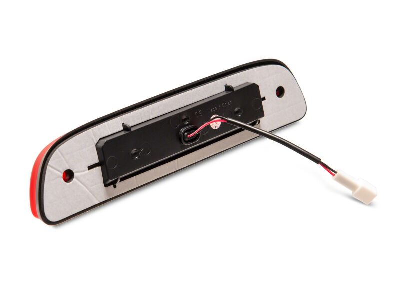 Red Raxiom Axial Series LED third brake light for 2005-2015 Toyota Tacoma, mounted on rear vehicle with clear lens.