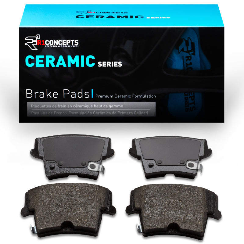 R1 Concepts Dodge Magnum rear ceramic brake pads, OE type, with visible brake pad surfaces and backing plates.