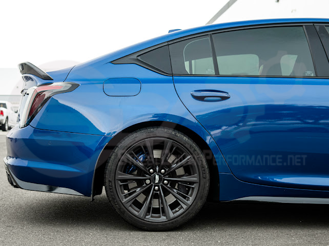 Pair of carbon fiber mud flaps for 2022-up Cadillac CT5-V Blackwing, made by Street Driven Performance, installed on front and rear wheels.