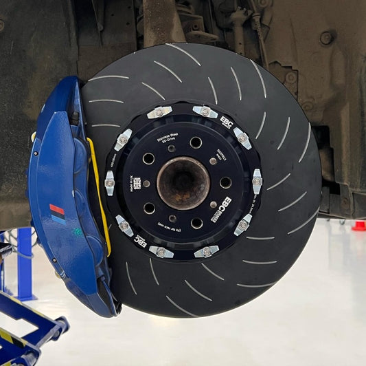 EBC Racing 11-19 BMW M5 M6 4.4L 2-piece SG front brake rotors on vehicle, showing detailed vented disc design.