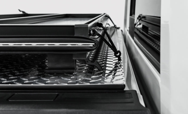 Access LOMAX Pro Series tri-fold hard tonneau cover for 6ft 6in Chevy/GMC 1500 bed in black diamond mist finish.