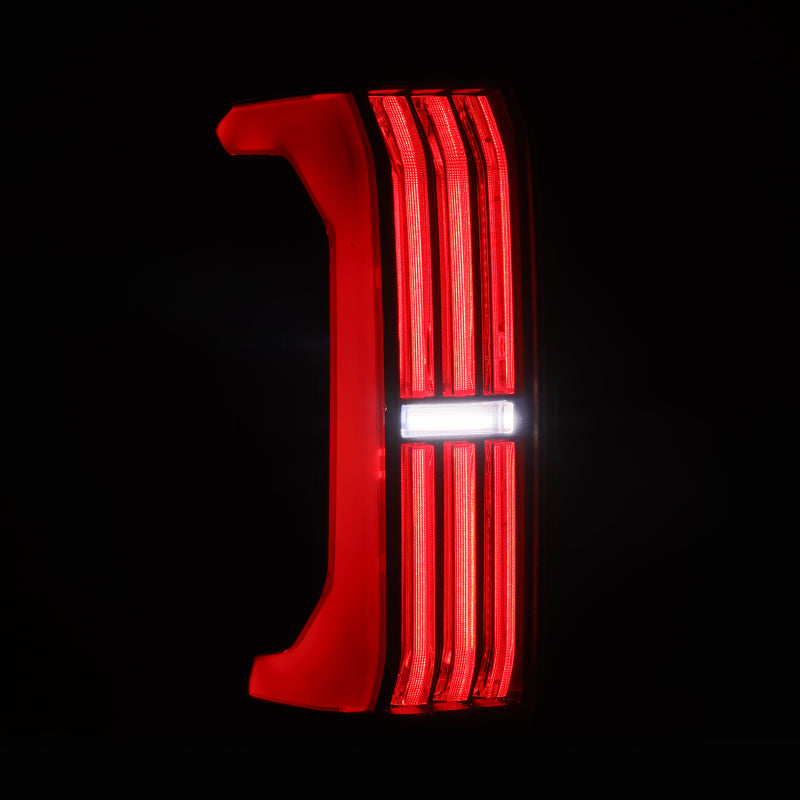 AlphaRex Nova-Series LED tail lights in Alpha-Black for 24-25 Toyota Tacoma, featuring prismatic lens design.
