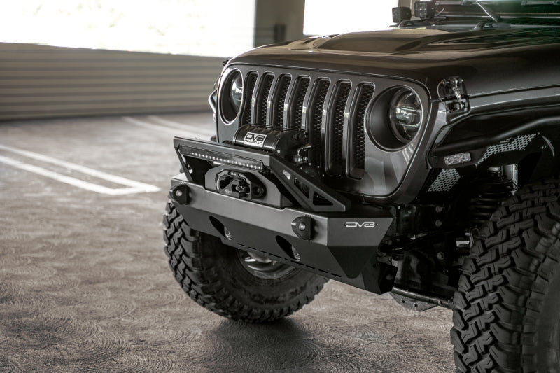 Steel DV8 Offroad FS-25 stubby front bumper with plated bull bar on Jeep Wrangler and Gladiator JT/JK/JL, rugged off-road design.