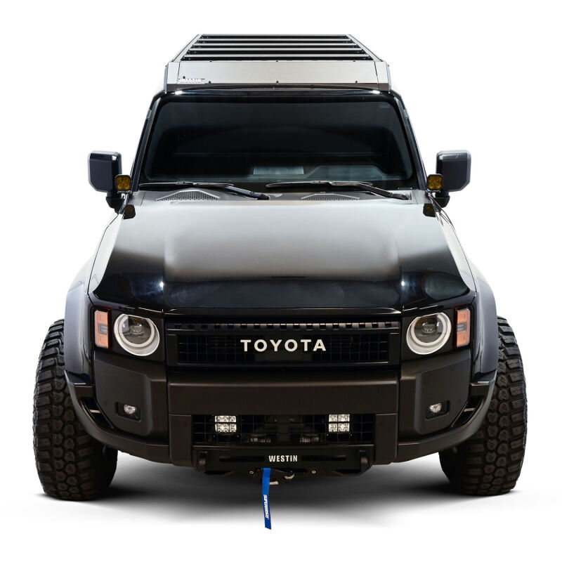 Westin 2026 Toyota Land Cruiser Mesa roof rack installed on top of the vehicle, showcasing durable metal construction for outdoor gear transport.