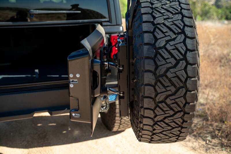 DV8 Offroad Jeep Wrangler JL MTO Series bumper tailgate swing gate with spare tire carrier, offroad accessory for 2018-2023 models.
