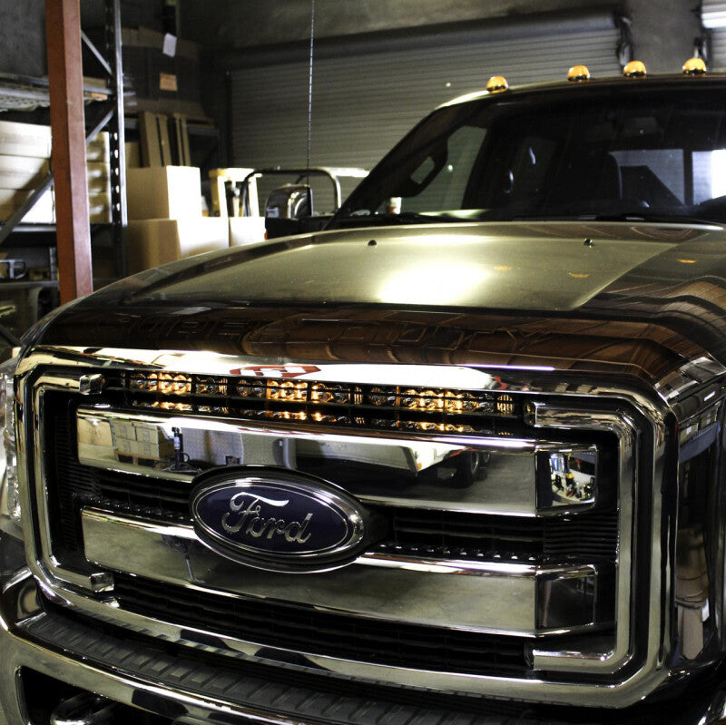 Baja Designs 30-inch S8 Series LED light bar kit installed on a Ford Super Duty truck grille, providing bright off-road illumination.